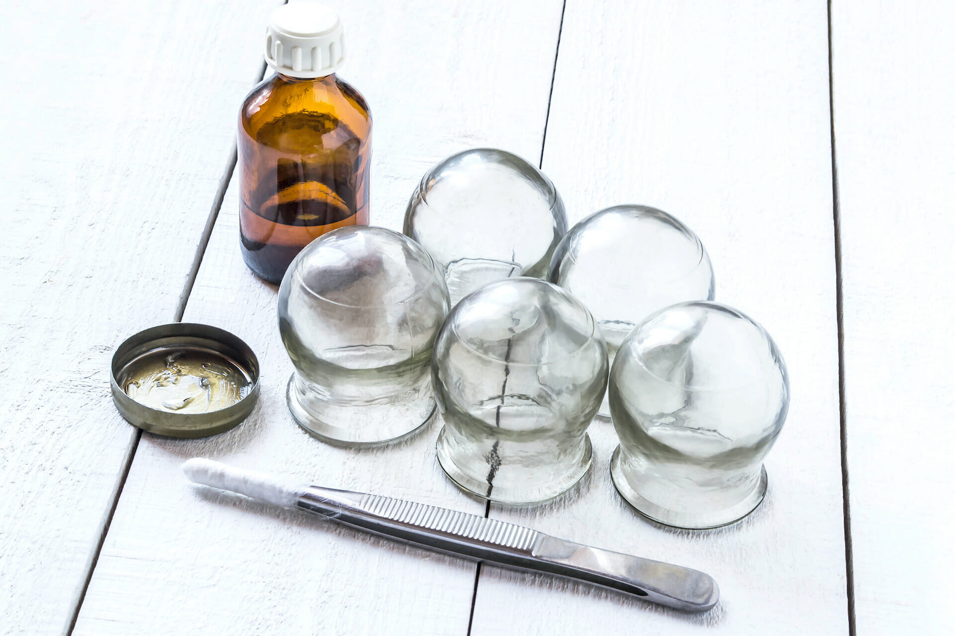 Old medical cupping glass, the alcohol in the bubble, and petrolatum tweezers with cottonwool